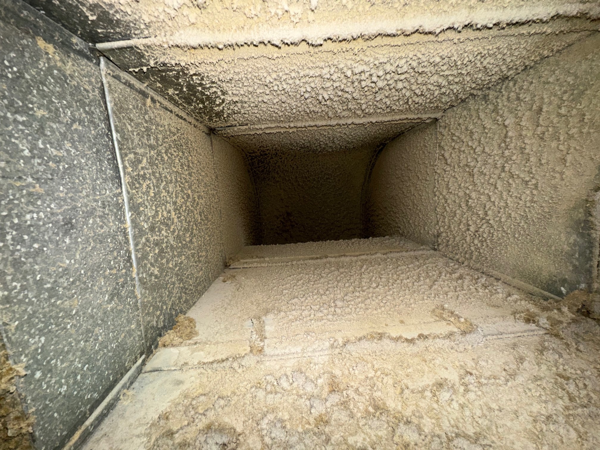 HVAC duct with accumulated dust and debris